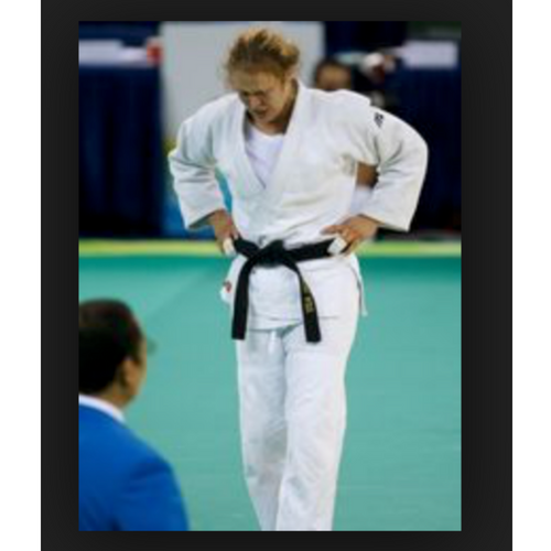 Ronda Rousey competing in Judo as a blackbelt in the Olympics with taped fingers or buddy tape